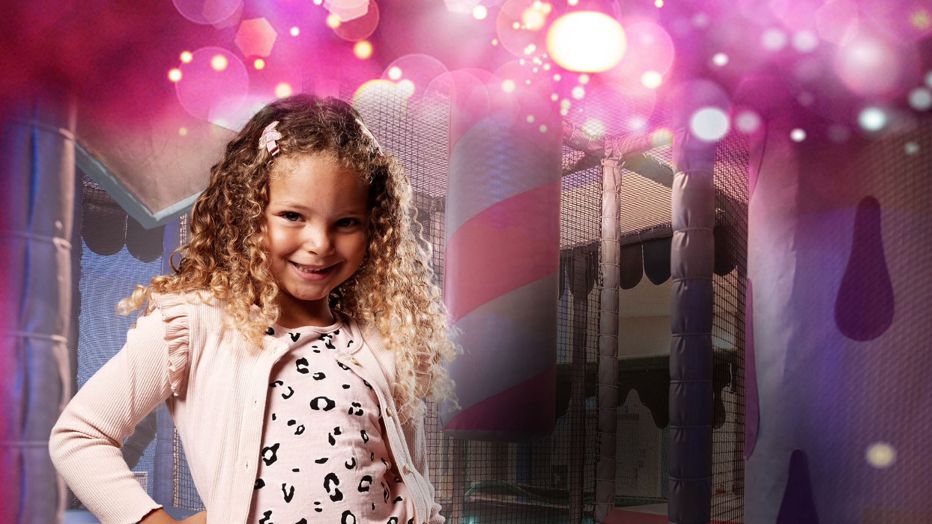 Child smiling and playing in indoor soft play area at Kidspace Romford